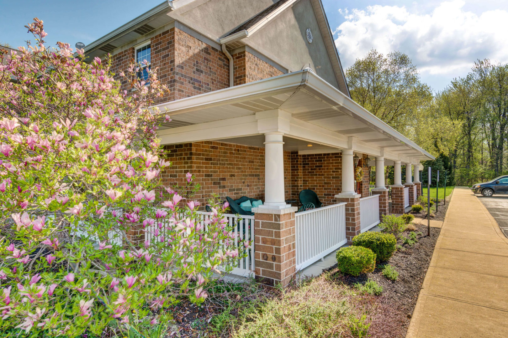 a house with a porch and a white fence