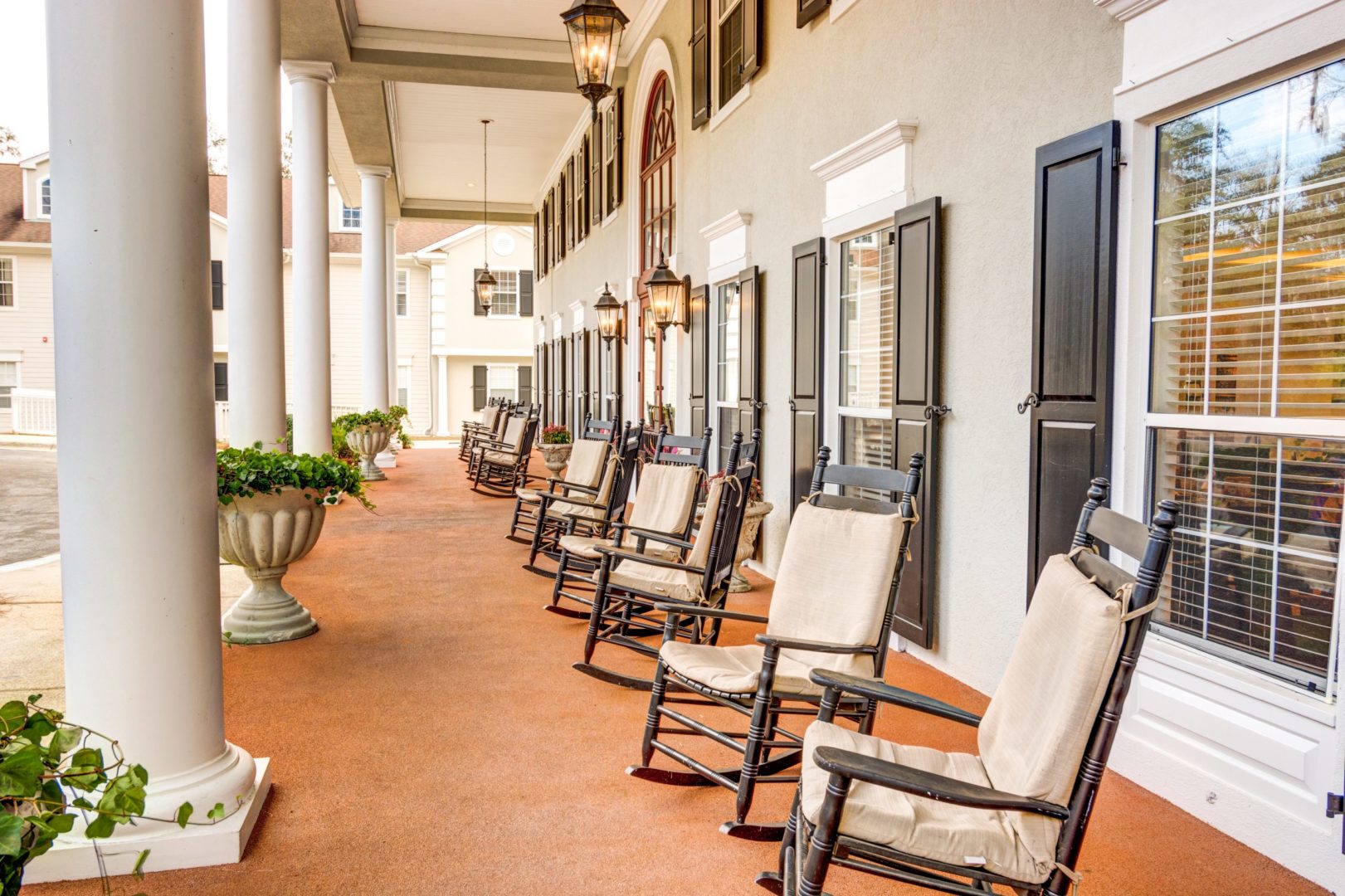 a row of chairs on a porch