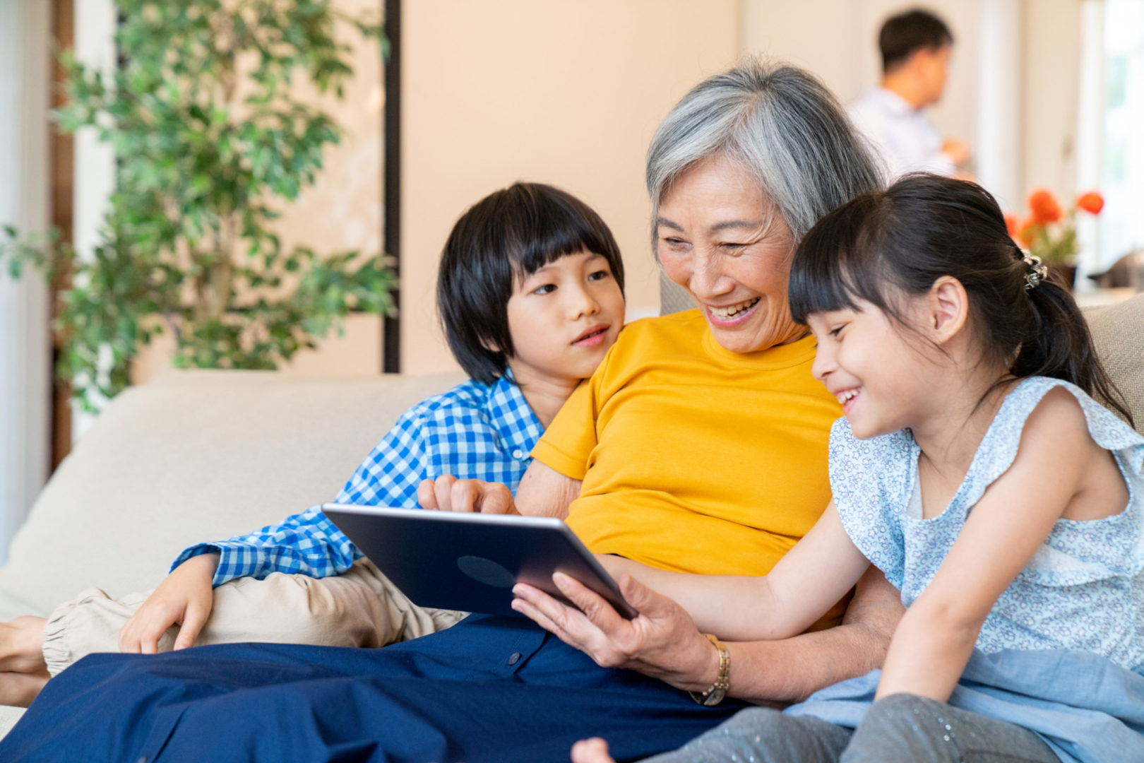 a person and children looking at a tablet