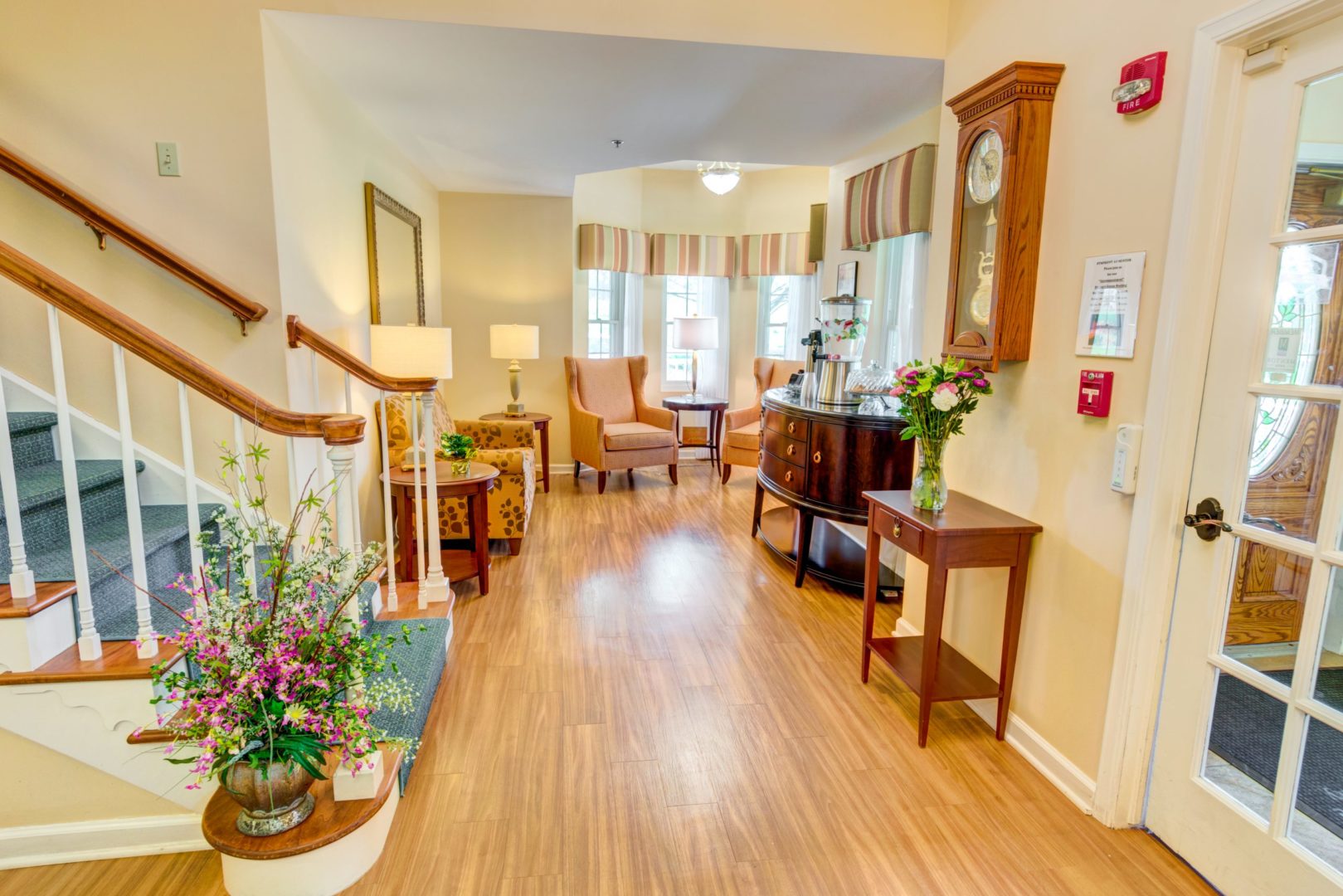 a room with a staircase and a table and chairs