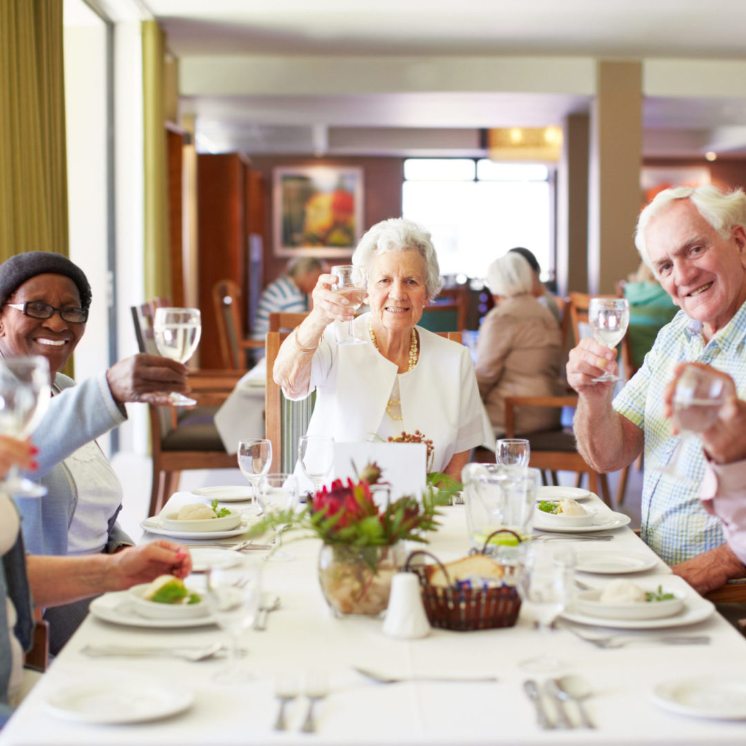 a group of people sitting at a table with wine glasses