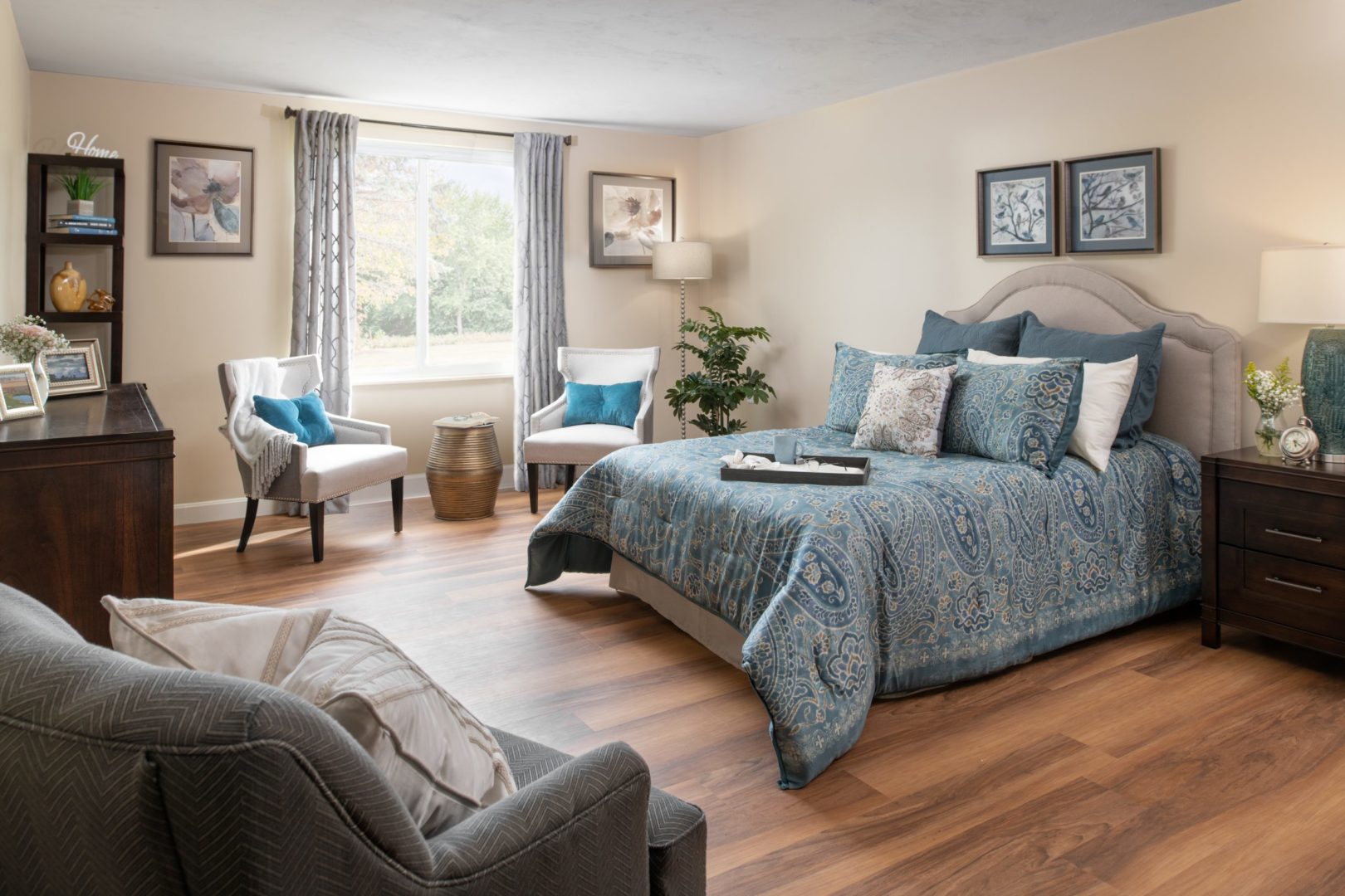 a bedroom with a bed and chairs