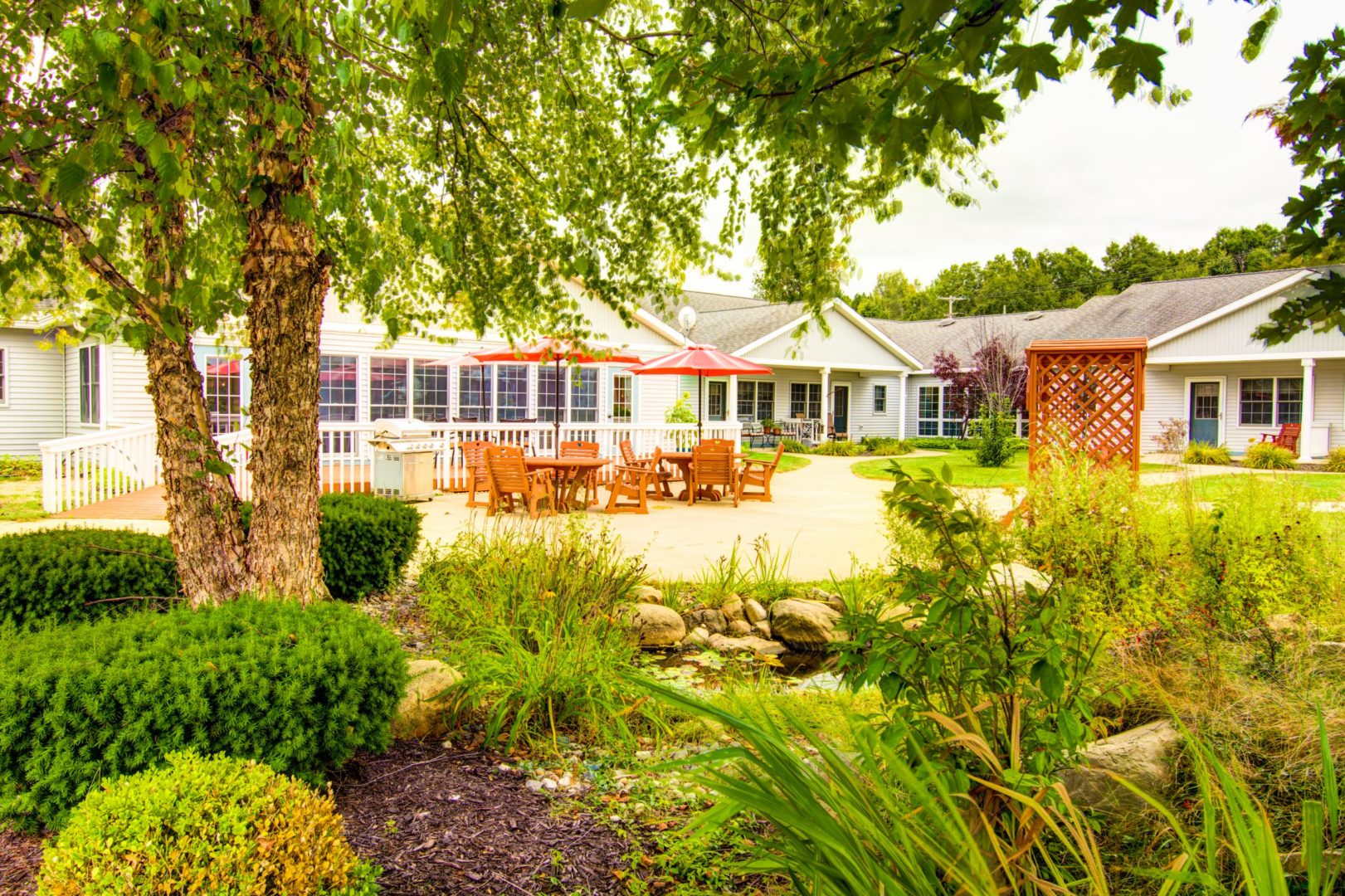 a white house with a patio and trees