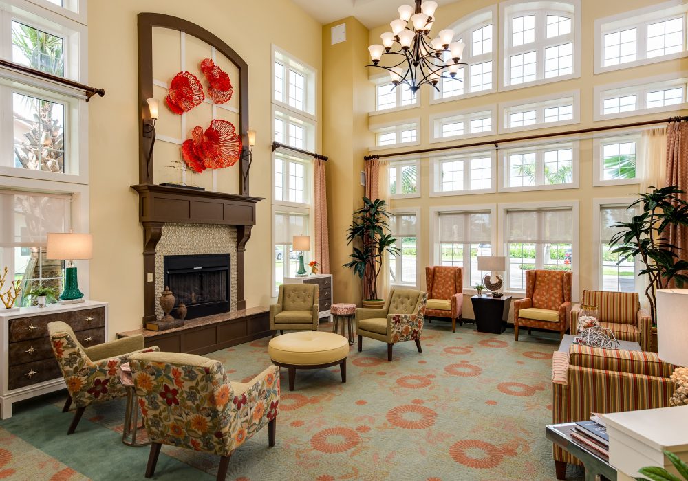 a room with a fireplace and chairs