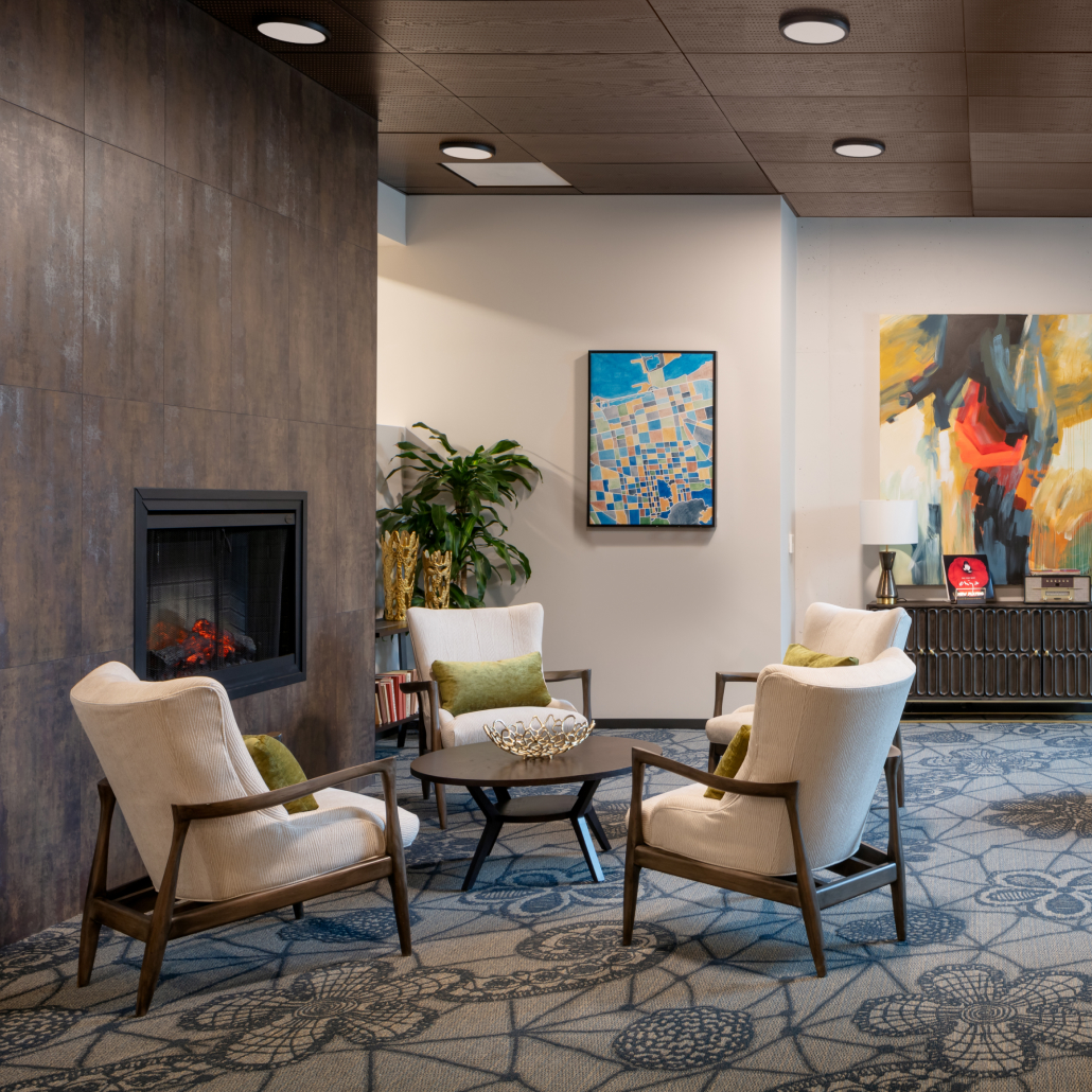 a room with a fireplace and chairs