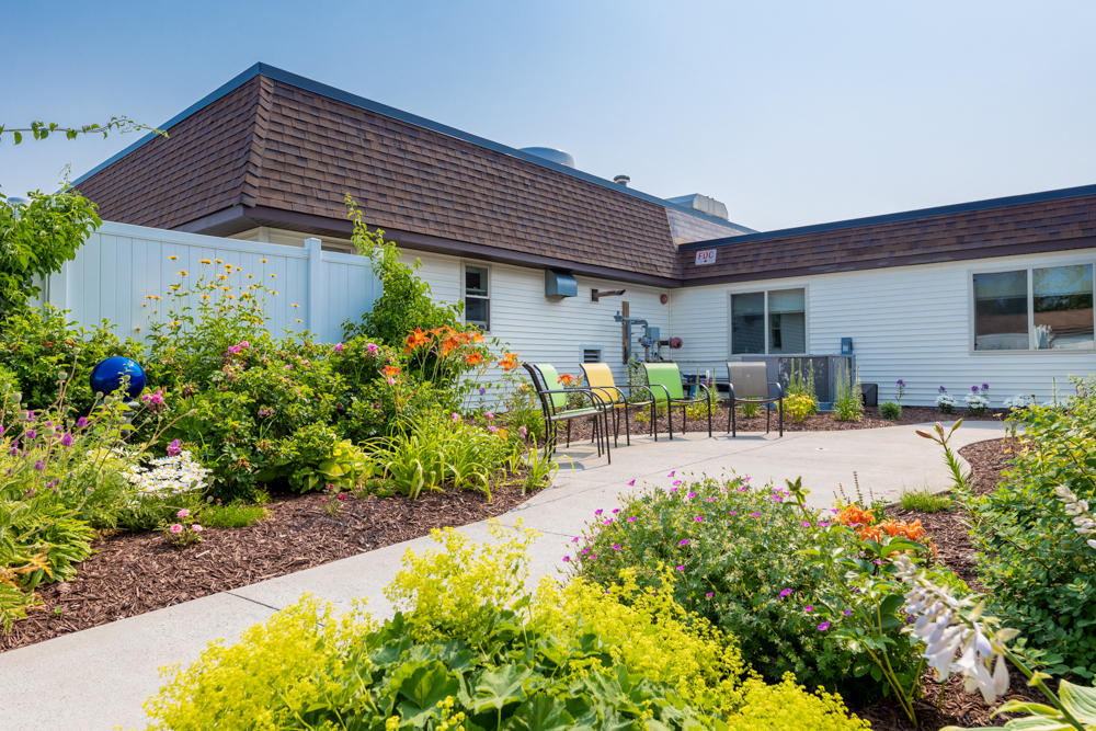 a house with a garden and chairs