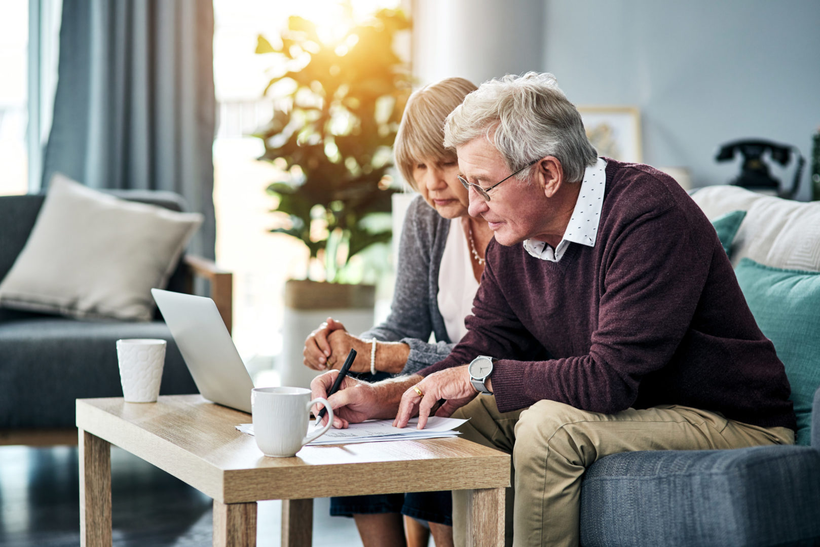 a person and person looking at papers on a table