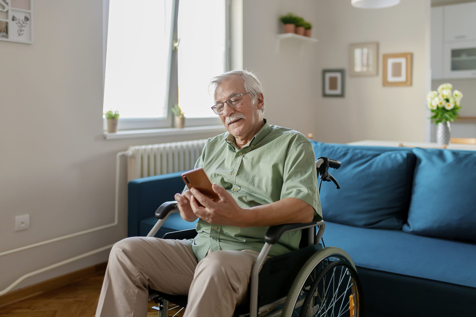a person in a wheelchair looking at his phone