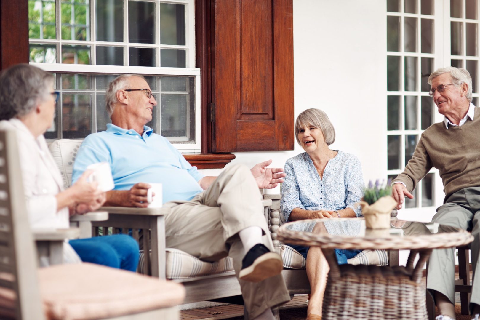 a group of people sitting on a porch