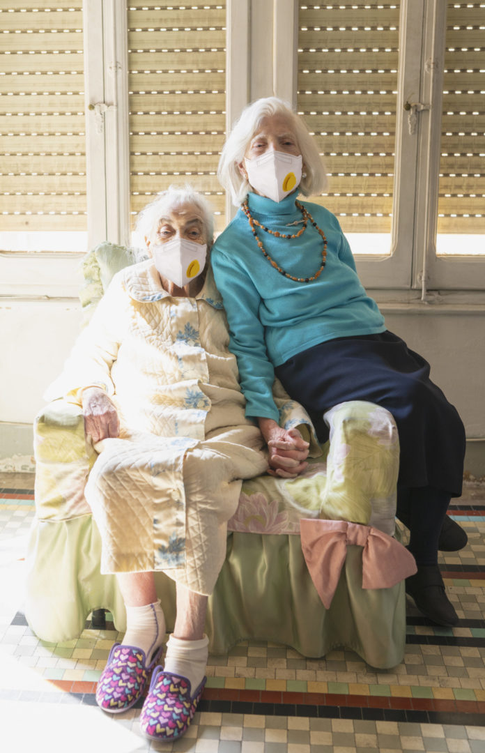 two women wearing face masks