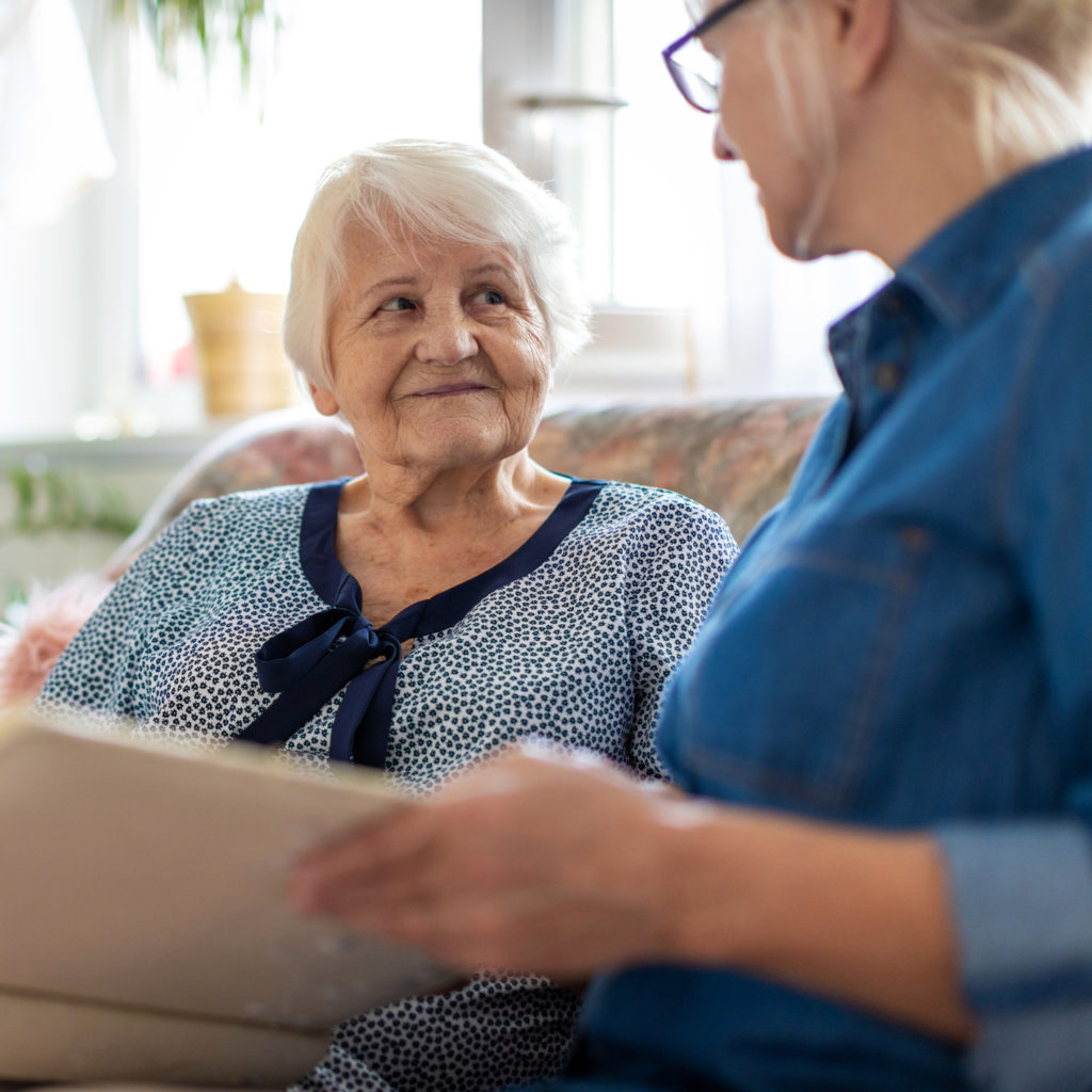 a person looking at a person holding a paper