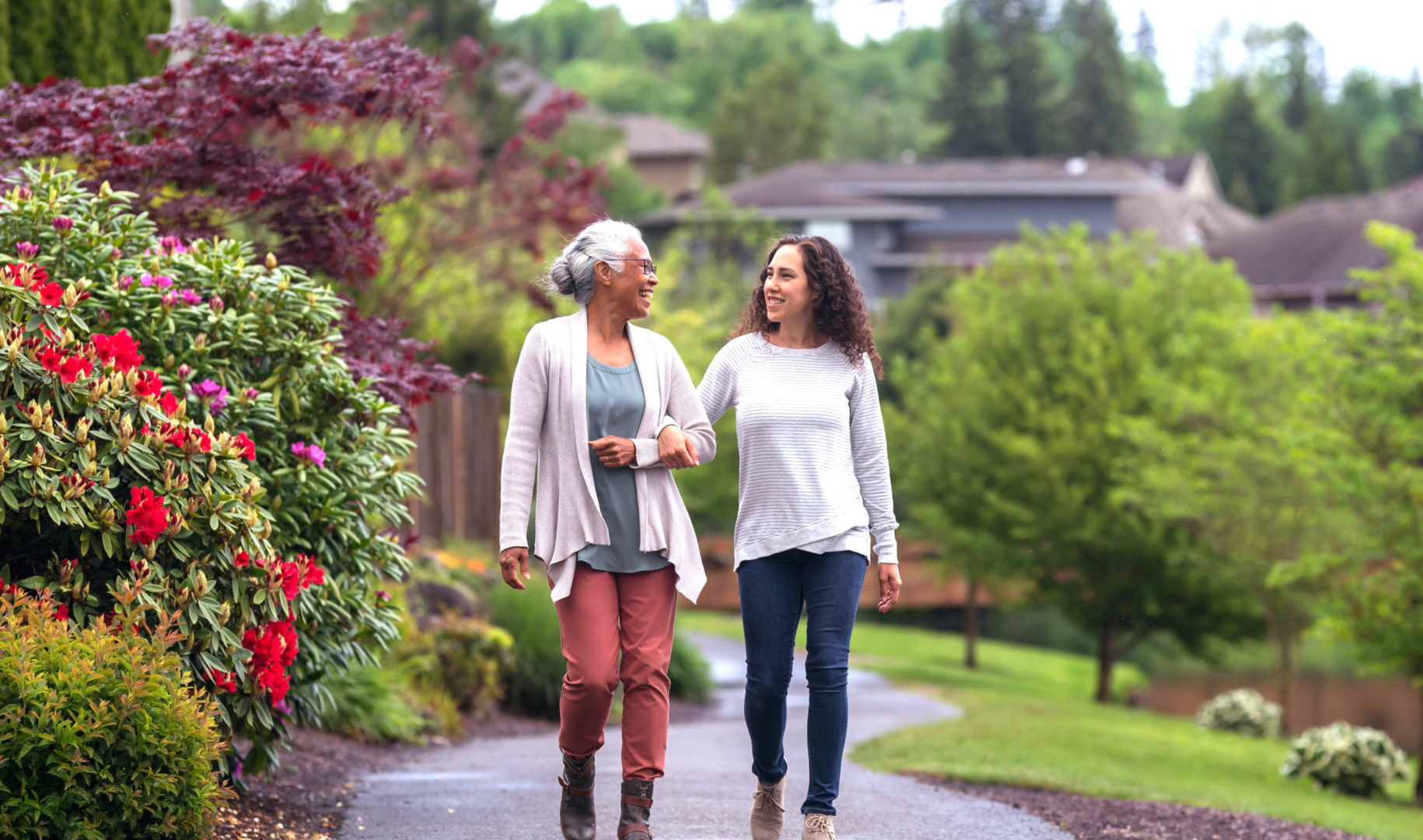 a person and a young person walking on a path
