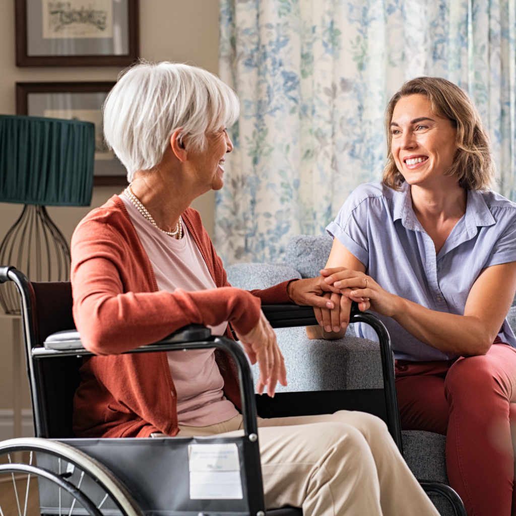 a person and a person sitting in a wheelchair