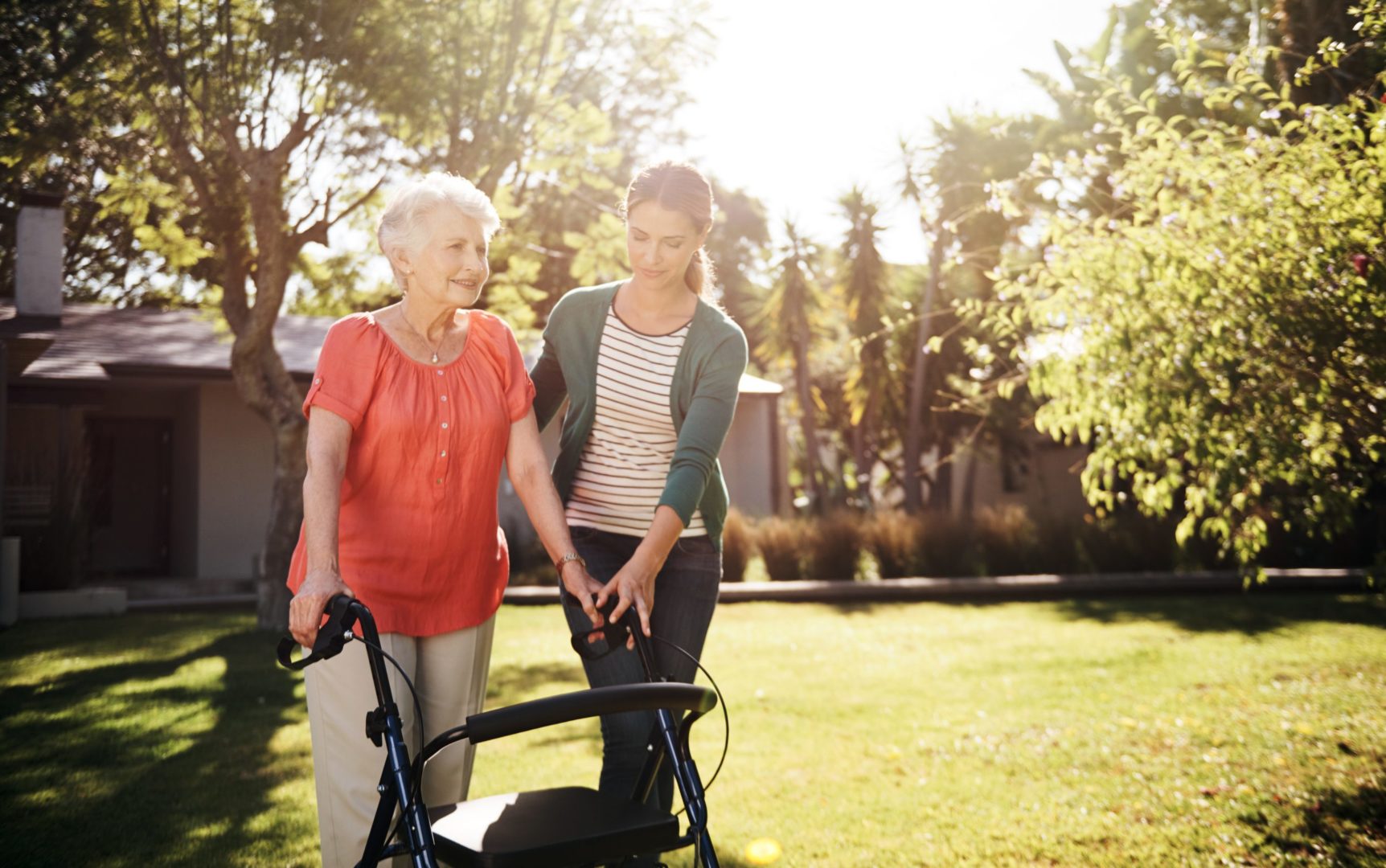 a person pushing a walker with an older person