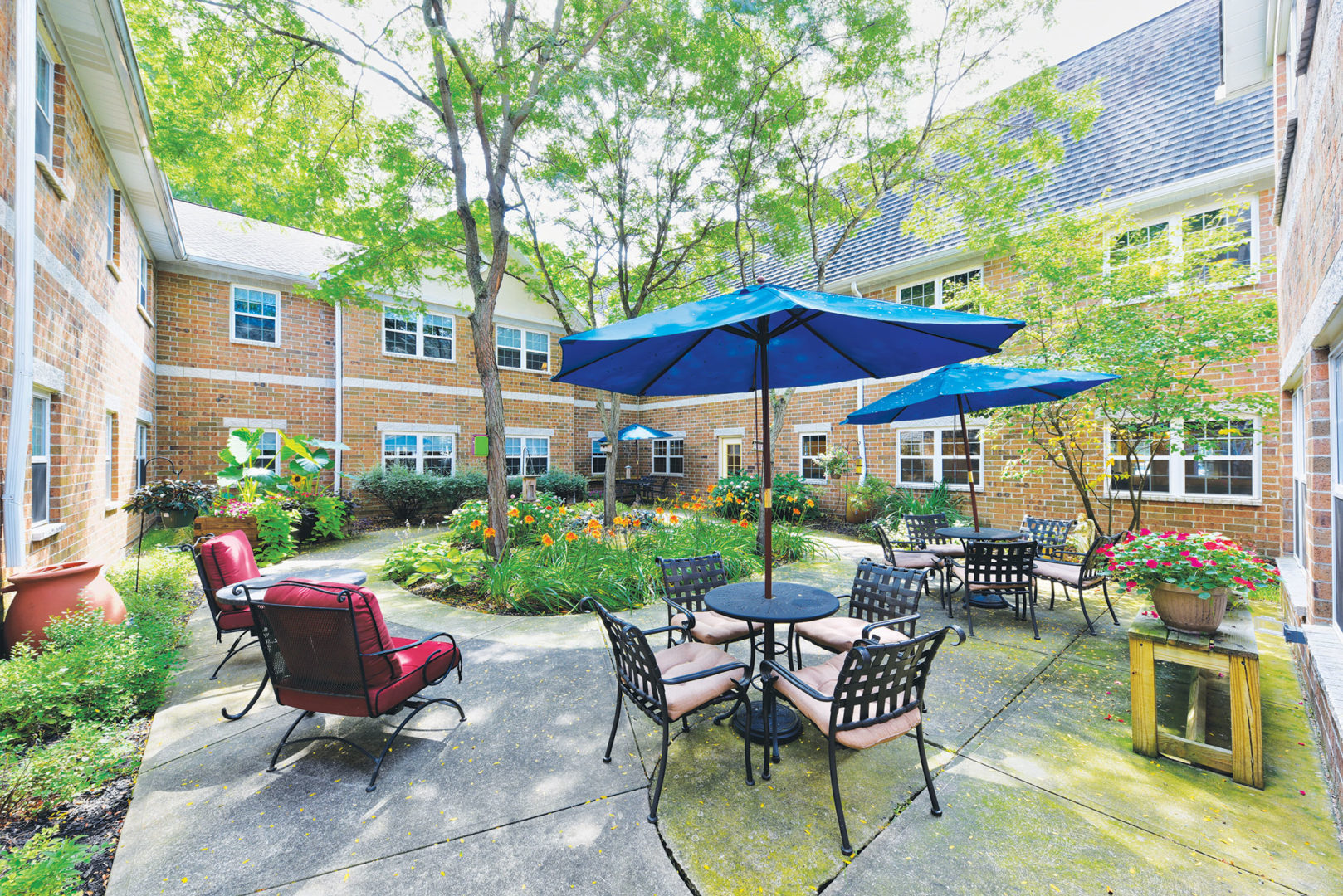 a patio area with chairs and umbrellas