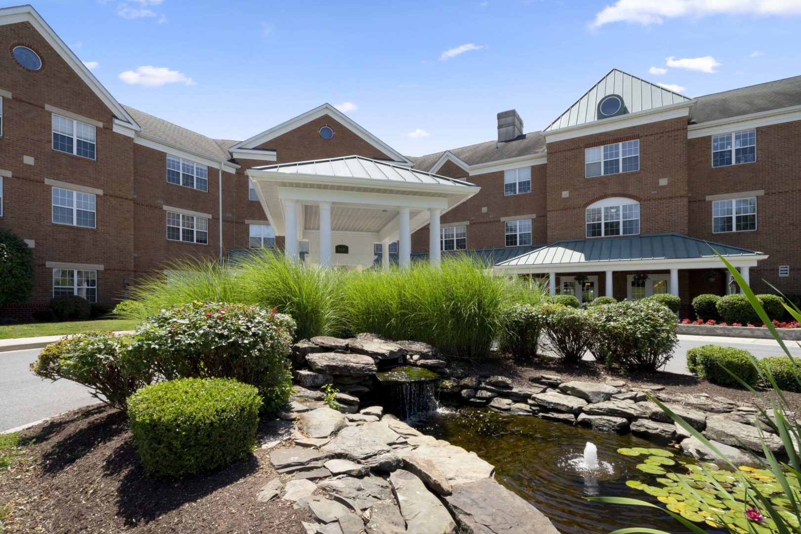 a building with a fountain and a pond