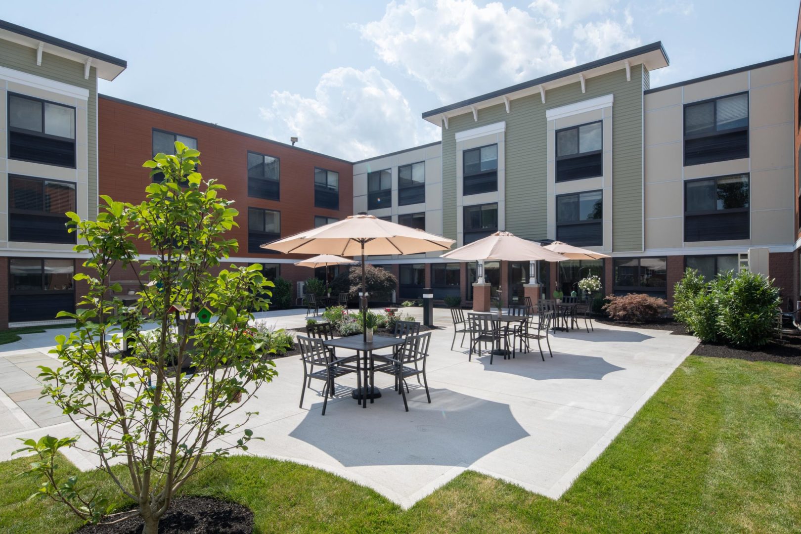 a building with a patio and umbrellas