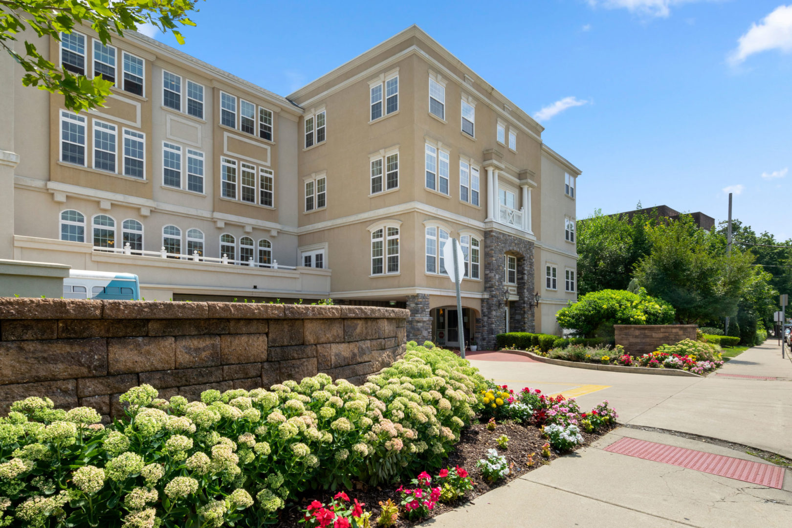 a building with flowers and a sidewalk
